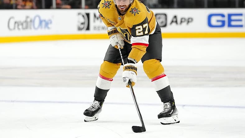Oct 17, 2023; Las Vegas, Nevada, USA; Vegas Golden Knights defenseman Shea Theodore (27) prepares for a face off against the Dallas Stars during the third period at T-Mobile Arena. Mandatory Credit: Stephen R. Sylvanie-USA TODAY Sports