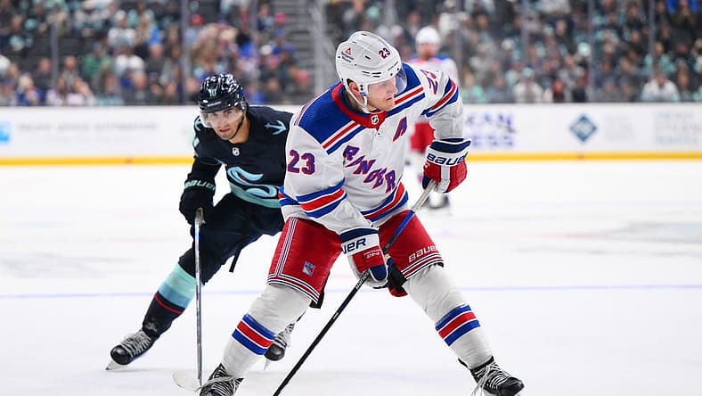 Oct 21, 2023; Seattle, Washington, USA; New York Rangers defenseman Adam Fox (23) plays the puck during the third period against the New York Rangers at Climate Pledge Arena. Mandatory Credit: Steven Bisig-USA TODAY Sports
