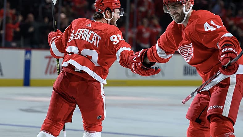 Oct 24, 2023; Detroit, Michigan, USA; Detroit Red Wings right wing Alex DeBrincat (93) celebrates with defenseman Shayne Gostisbehere (41)after scoring a power play goal against the Seattle Kraken in the third period at Little Caesars Arena. Mandatory Credit: Lon Horwedel-USA TODAY Sports