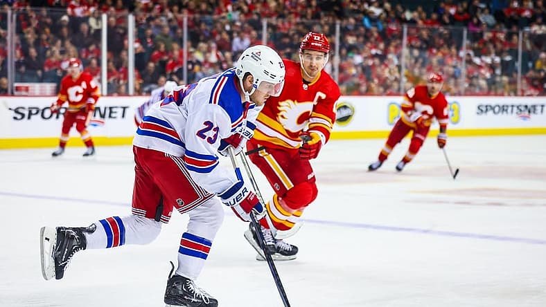 Oct 24, 2023; Calgary, Alberta, CAN; New York Rangers defenseman Adam Fox (23) skates with the puck against the Calgary Flames during the second period at Scotiabank Saddledome. Mandatory Credit: Sergei Belski-USA TODAY Sports
