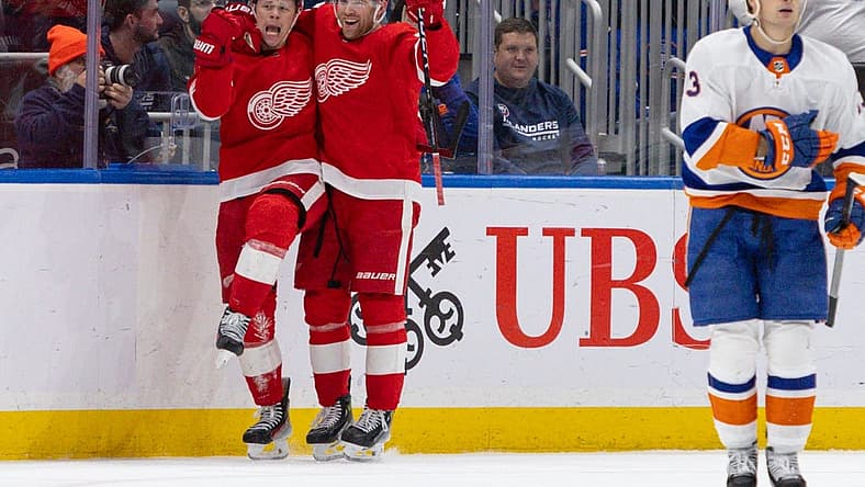 Oct 30, 2023; Elmont, New York, USA; Detroit Red Wings left wing Lucas Raymond (23) celebrates his winning goal with left wing J.T. Compher (37)against the New York Islanders during overtime at UBS Arena. Mandatory Credit: Thomas Salus-USA TODAY Sports