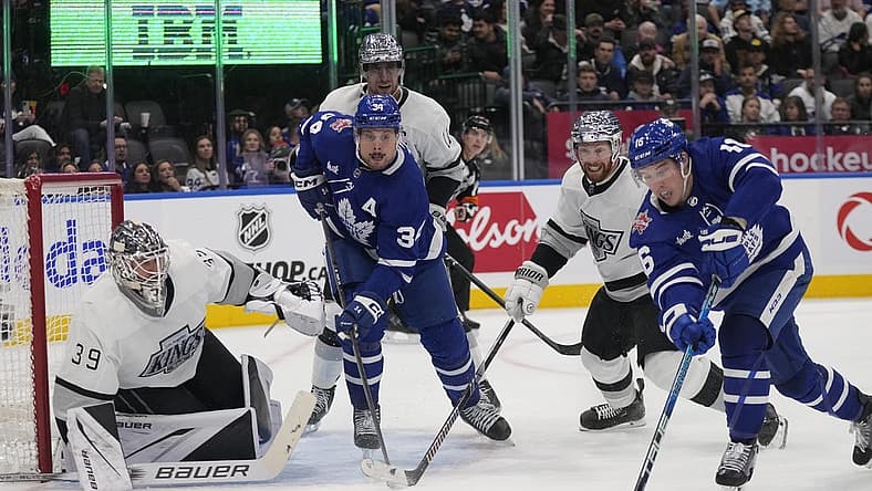 Oct 31, 2023; Toronto, Ontario, CAN; Toronto Maple Leafs forward Mitchell Marner (16) tries to get on shot off at Los Angeles Kings goaltender Cam Talbot (39) as Toronto Maple Leafs forward Auston Matthews (34) and Los Angeles Kings defenseman Vladislav Gavrikov (84) look on during the third period at Scotiabank Arena. Mandatory Credit: John E. Sokolowski-USA TODAY Sports