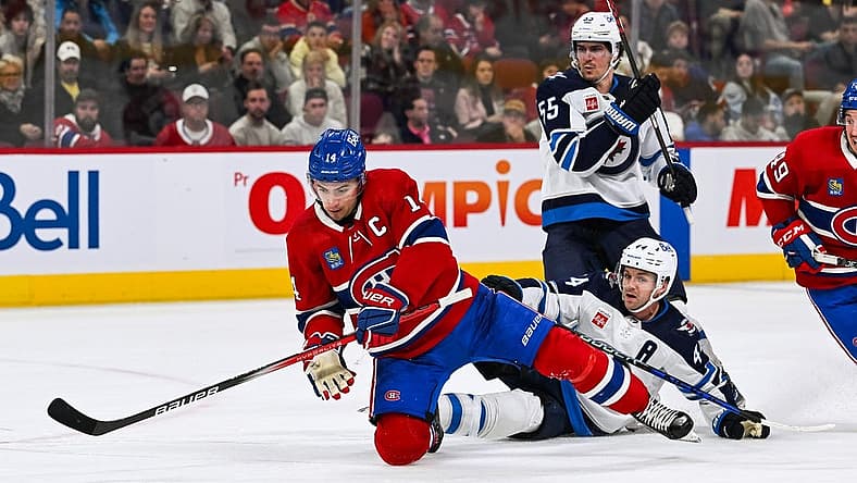 Oct 28, 2023; Montreal, Quebec, CAN; Montreal Canadiens center Nick Suzuki (14) and Winnipeg Jets defenseman Josh Morrissey (44) during the second period at Bell Centre. Mandatory Credit: David Kirouac-USA TODAY Sports