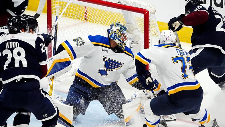 Nov 1, 2023; Denver, Colorado, USA; St. Louis Blues goaltender Jordan Binnington (50) makes a save on Colorado Avalanche right wing Logan O'Connor (25) as defenseman Justin Faulk (72) defends in the first period at Ball Arena. Mandatory Credit: Ron Chenoy-USA TODAY Sports