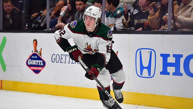 Nov 1, 2023; Anaheim, California, USA; Arizona Coyotes center Logan Cooley (92) moves the puck against the Anaheim Ducks during the second period at Honda Center. Mandatory Credit: Gary A. Vasquez-USA TODAY Sports