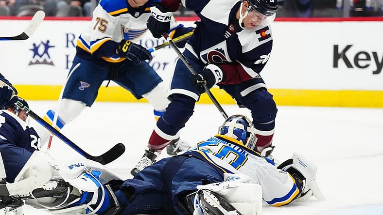 Nov 1, 2023; Denver, Colorado, USA; St. Louis Blues goaltender Jordan Binnington (50) makes a save on Colorado Avalanche center Ross Colton (20) in the second period at Ball Arena. Mandatory Credit: Ron Chenoy-USA TODAY Sports