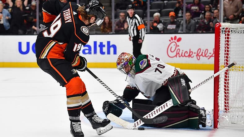 Nov 1, 2023; Anaheim, California, USA; Arizona Coyotes goaltender Karel Vejmelka (70) blcoks a shot against Anaheim Ducks right wing Troy Terry (19) during the third period at Honda Center. Mandatory Credit: Gary A. Vasquez-USA TODAY Sports