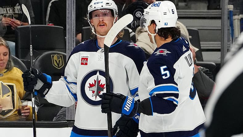 Nov 2, 2023; Las Vegas, Nevada, USA; Winnipeg Jets left wing Kyle Connor (81) celebrates with Winnipeg Jets defenseman Brenden Dillon (5) after scoring a goal against the Vegas Golden Knights during the second period at T-Mobile Arena. Mandatory Credit: Stephen R. Sylvanie-USA TODAY Sports