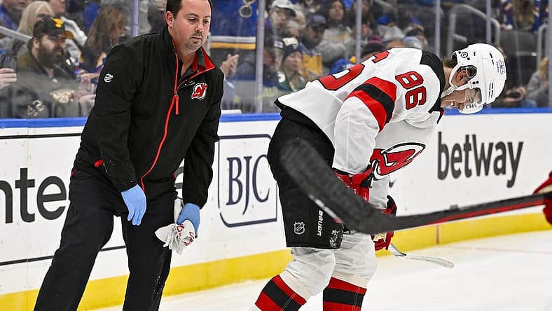 Nov 3, 2023; St. Louis, Missouri, USA; New Jersey Devils center Jack Hughes (86) is checked on by a trainer after slamming in to the boards during the first period against the St. Louis Blues at Enterprise Center. Mandatory Credit: Jeff Curry-USA TODAY Sports