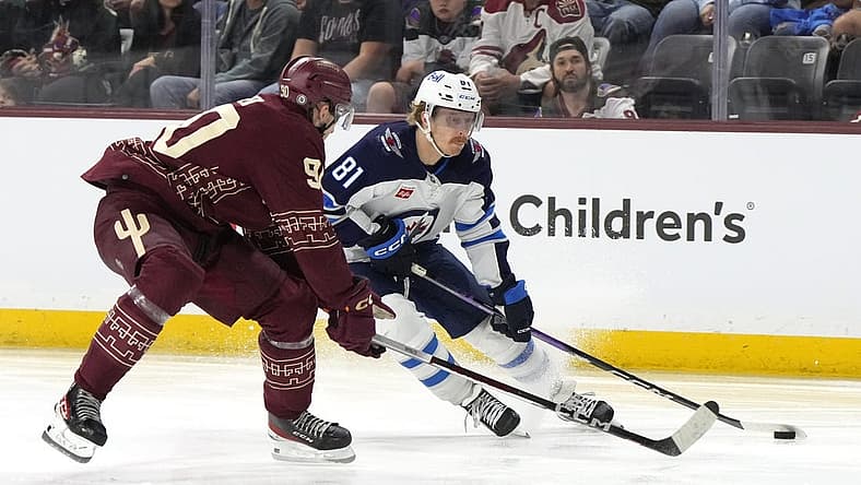 Nov 4, 2023; Tempe, Arizona, USA; Winnipeg Jets left wing Kyle Connor (81) skates around Arizona Coyotes defenseman J.J. Moser (90) in the third period at Mullett Arena. Mandatory Credit: Rick Scuteri-USA TODAY Sports