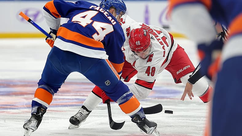 Nov 4, 2023; Elmont, New York, USA; New York Islanders center Jean-Gabriel Pageau (44) and Carolina Hurricanes left wing Jordan Martinook (48) take a face-off during the first period at UBS Arena. Mandatory Credit: Brad Penner-USA TODAY Sports