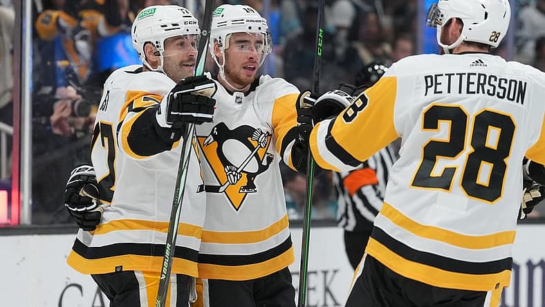 Nov 4, 2023; San Jose, California, USA; Pittsburgh Penguins right wing Reilly Smith (center) celebrates with right wing Bryan Rust (left) and defenseman Marcus Pettersson (28) after scoring a goal against the San Jose Sharks during the first period at SAP Center at San Jose. Mandatory Credit: Darren Yamashita-USA TODAY Sports