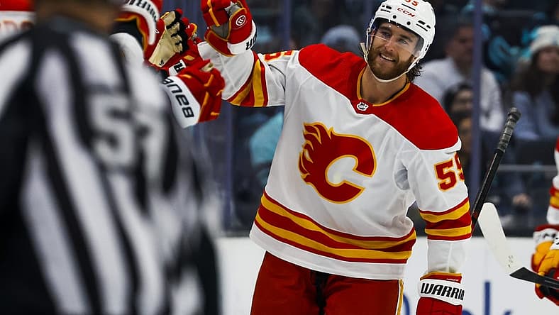 Nov 4, 2023; Seattle, Washington, USA; Calgary Flames defenseman Noah Hanifin (55) celebrates after scoring a goal against the Seattle Kraken during the second period at Climate Pledge Arena. Mandatory Credit: Joe Nicholson-USA TODAY Sports