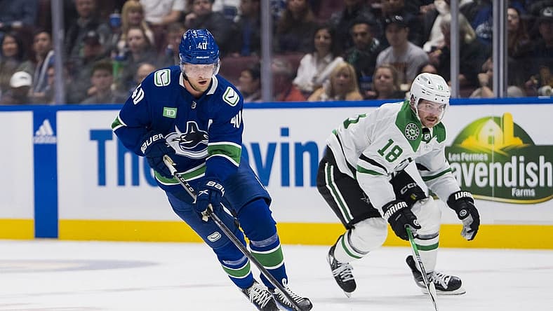 Nov 4, 2023; Vancouver, British Columbia, CAN; Dallas Stars forward Sam Steel (18) watches as Vancouver Canucks forward Elias Pettersson (40) drives up ice in the third period at Rogers Arena. Vancouver won 2-0. Mandatory Credit: Bob Frid-USA TODAY Sports