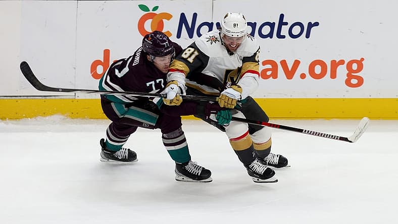 Nov 5, 2023; Anaheim, California, USA; Anaheim Ducks right wing Frank Vatrano (77) and Vegas Golden Knights right wing Jonathan Marchessault (81) battle for the puck during the second period at Honda Center. Mandatory Credit: Jason Parkhurst-USA TODAY Sports