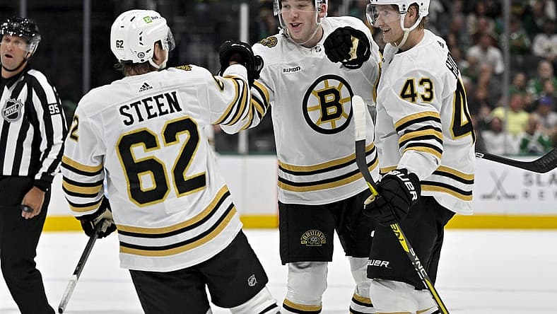 Nov 6, 2023; Dallas, Texas, USA; Boston Bruins defenseman Ian Mitchell (14) and defenseman Mason Lohrei (6) and left wing Danton Heinen (43) and center Oskar Steen (62) celebrates a goal scored by Lohrei against the Dallas Stars during the first period at the American Airlines Center. Mandatory Credit: Jerome Miron-USA TODAY Sports