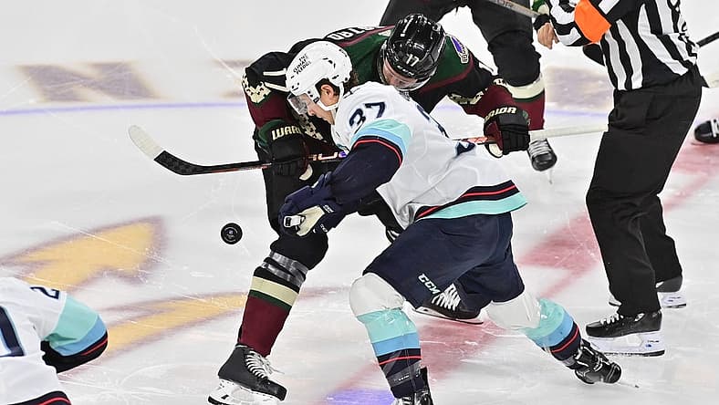 Nov 7, 2023; Tempe, Arizona, USA; Arizona Coyotes center Nick Bjugstad (17) and Seattle Kraken center Yanni Gourde (37) take the opening face off in the first period at Mullett Arena. Mandatory Credit: Matt Kartozian-USA TODAY Sports