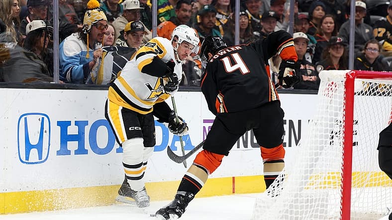 Nov 7, 2023; Anaheim, California, USA; Pittsburgh Penguins center Sidney Crosby (87) and Anaheim Ducks defenseman Cam Fowler (4) fights for the puck during the first period at Honda Center. Mandatory Credit: Kiyoshi Mio-USA TODAY Sports