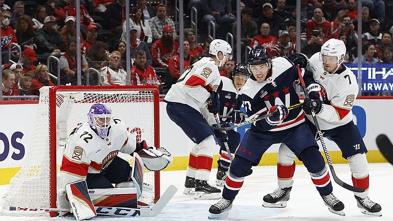 Nov 8, 2023; Washington, District of Columbia, USA; Washington Capitals right wing T.J. Oshie (77) and Florida Panthers defenseman Dmitry Kulikov (7) battle for the puck in front of Panthers goaltender Sergei Bobrovsky (72) in the first period at Capital One Arena. Mandatory Credit: Geoff Burke-USA TODAY Sports