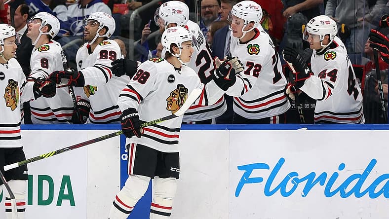 Nov 9, 2023; Tampa, Florida, USA; Chicago Blackhawks center Connor Bedard (98) is congratulated after he scored a goal against the Tampa Bay Lightning during the first period at Amalie Arena. Mandatory Credit: Kim Klement Neitzel-USA TODAY Sports