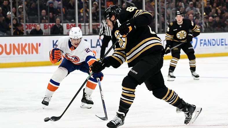 Nov 9, 2023; Boston, Massachusetts, USA; Boston Bruins right wing David Pastrnak (88) attempts a shot in front of New York Islanders right wing Hudson Fasching (20) during the first period at the TD Garden. Mandatory Credit: Brian Fluharty-USA TODAY Sports