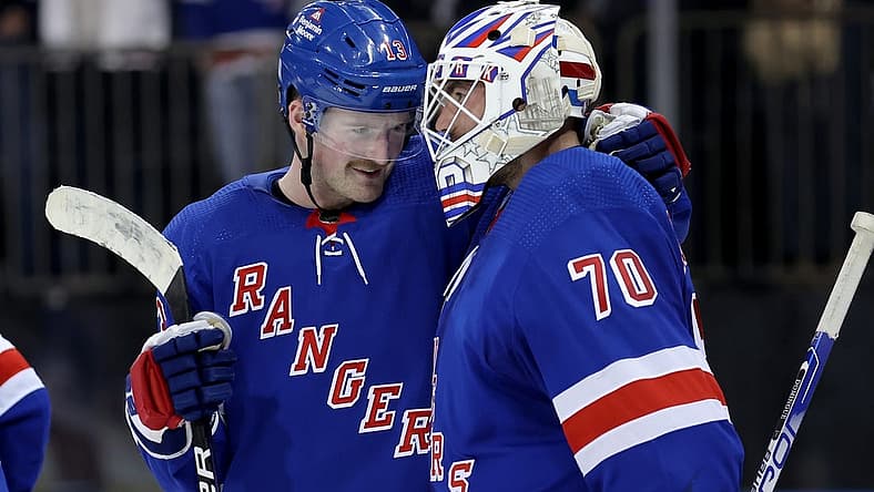 Nov 9, 2023; New York, New York, USA; New York Rangers left wing Alexis Lafreniere (13) celebrates with goaltender Louis Domingue (70) after defeating the Minnesota Wild at Madison Square Garden. Mandatory Credit: Brad Penner-USA TODAY Sports