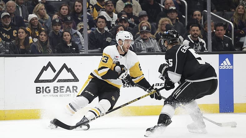 Nov 9, 2023; Los Angeles, California, USA; Pittsburgh Penguins left wing Radim Zohorna (63) makes a play against Los Angeles Kings defensemen Andreas Englund (5) during the first period at Crypto.com Arena. Mandatory Credit: Yannick Peterhans-USA TODAY Sports
