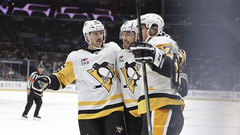 Nov 9, 2023; Los Angeles, California, USA; Pittsburgh Penguins defensemen Erik Karlsson (65), defensemen Kris Letang (58) and center Sidney Crosby (87) celebrate after a goal by center Sidney Crosby (87) in the first period against the Los Angeles Kings at Crypto.com Arena. Mandatory Credit: Yannick Peterhans-USA TODAY Sports