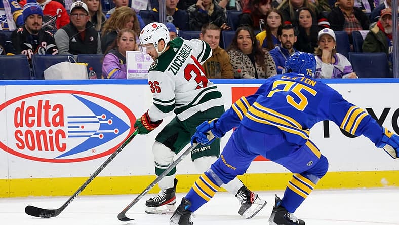 Nov 10, 2023; Buffalo, New York, USA; Minnesota Wild right wing Mats Zuccarello (36) carries the puck as Buffalo Sabres defenseman Connor Clifton (75) defends during the first period at KeyBank Center. Mandatory Credit: Timothy T. Ludwig-USA TODAY Sports