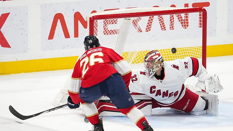 Nov 10, 2023; Sunrise, Florida, USA; Florida Panthers defenseman Uvis Balinskis (26) scores a goal past Carolina Hurricanes goaltender Antti Raanta (32) during the first period at Amerant Bank Arena. Mandatory Credit: Jasen Vinlove-USA TODAY Sports