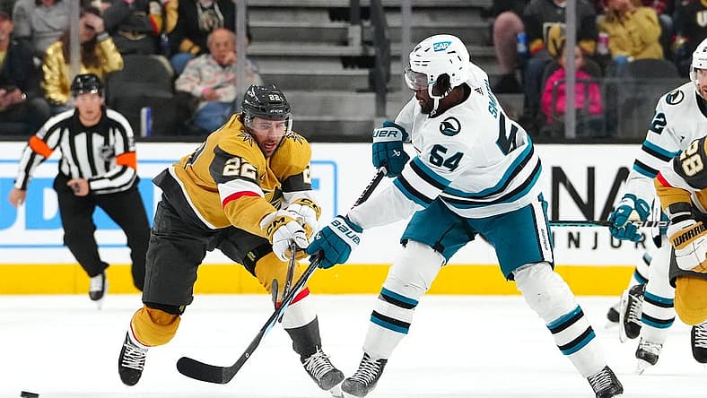 Nov 10, 2023; Las Vegas, Nevada, USA; San Jose Sharks right wing Givani Smith (54) makes a pass in front of Vegas Golden Knights right wing Michael Amadio (22) during the first period at T-Mobile Arena. Mandatory Credit: Stephen R. Sylvanie-USA TODAY Sports
