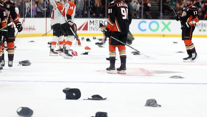 Nov 10, 2023; Anaheim, California, USA; Fans throw hats as Anaheim Ducks center Leo Carlsson (91) records a hat trick during the third period against the Philadelphia Flyers at Honda Center. Mandatory Credit: Kiyoshi Mio-USA TODAY Sports