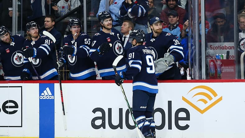 Nov 11, 2023; Winnipeg, Manitoba, CAN; Winnipeg Jets forward Cole Perfetti (91) is congratulated by his teammates on his goal against the Dallas Stars during the second period at Canada Life Centre. Mandatory Credit: Terrence Lee-USA TODAY Sports