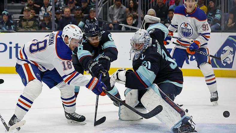 Nov 11, 2023; Seattle, Washington, USA; Edmonton Oilers left wing Zach Hyman (18) scores his second goal of the during the first period against Seattle Kraken goaltender Philipp Grubauer (31) and defenseman Adam Larsson (6)  at Climate Pledge Arena. Mandatory Credit: Joe Nicholson-USA TODAY Sports