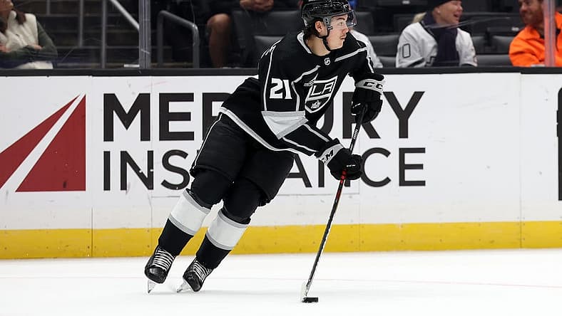 Nov 11, 2023; Los Angeles, California, USA; Los Angeles Kings defenseman Jordan Spence (21) controls the puck during the third period against the Philadelphia Flyers at Crypto.com Arena. Mandatory Credit: Kiyoshi Mio-USA TODAY Sports