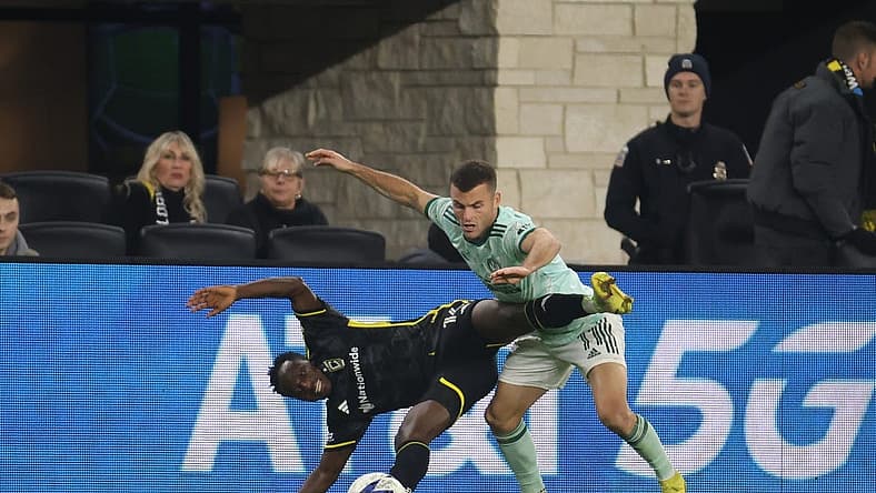 Nov 12, 2023; Columbus, Ohio, USA; Columbus Crew midfielder Yaw Yeboah (14) is challenged by Atlanta United FC defender Brooks Lennon (11) during the second half at Lower.com Field. Mandatory Credit: Trevor Ruszkowski-USA TODAY Sports