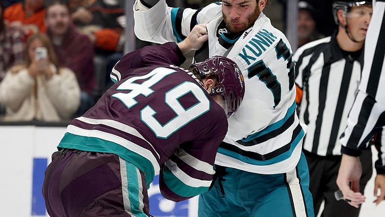 Nov 12, 2023; Anaheim, California, USA; San Jose Sharks center Luke Kunin (11) and Anaheim Ducks left wing Max Jones (49) fight during the second period at Honda Center. Mandatory Credit: Jason Parkhurst-USA TODAY Sports