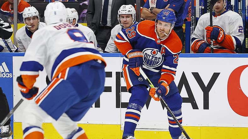 Nov 13, 2023; Edmonton, Alberta, CAN; Edmonton Oilers forward Leon Draisaitl (29) looks to make a pass in front of New York Islanders defensemen Noah Dobson (8) during the first period at Rogers Place. Mandatory Credit: Perry Nelson-USA TODAY Sports
