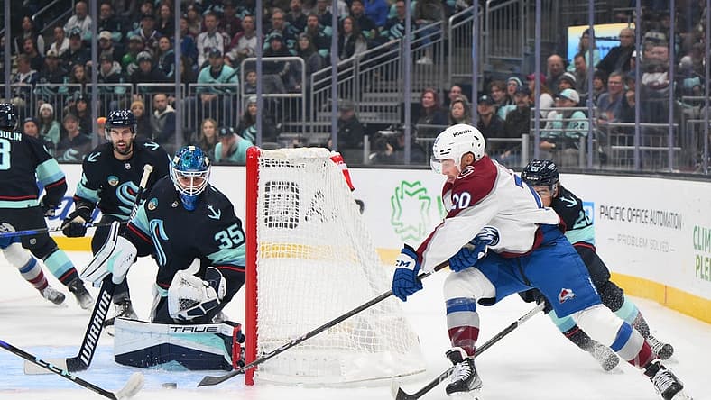 Nov 13, 2023; Seattle, Washington, USA; Seattle Kraken goaltender Joey Daccord (35) blocks a goal shot by Colorado Avalanche center Ross Colton (20) during the first period at Climate Pledge Arena. Mandatory Credit: Steven Bisig-USA TODAY Sports