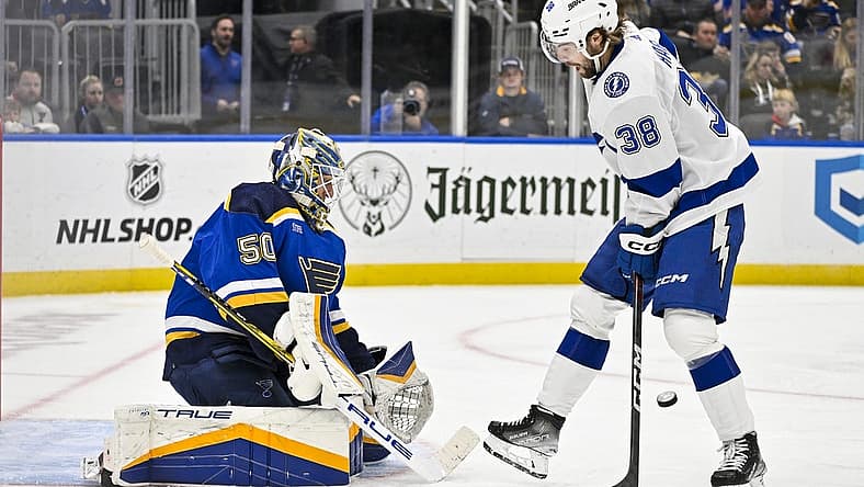 Nov 14, 2023; St. Louis, Missouri, USA;  St. Louis Blues goaltender Jordan Binnington (50) defends the net against Tampa Bay Lightning left wing Brandon Hagel (38) during the third period at Enterprise Center. Mandatory Credit: Jeff Curry-USA TODAY Sports