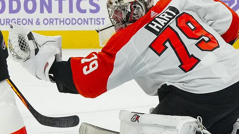 Nov 15, 2023; Raleigh, North Carolina, USA; Philadelphia Flyers goaltender Carter Hart (79) reaches out to make glove save against the Carolina Hurricanes during the first period at PNC Arena. Mandatory Credit: James Guillory-USA TODAY Sports