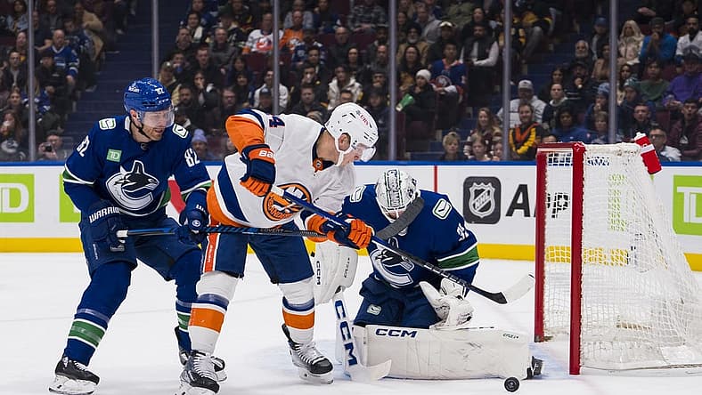 Nov 15, 2023; Vancouver, British Columbia, CAN; Vancouver Canucks goalie Thatcher Demko (35) watches the rebound as defenseman Ian Cole (82) battles with New York Islanders forward Bo Horvat (14) in the first period at Rogers Arena. Mandatory Credit: Bob Frid-USA TODAY Sports