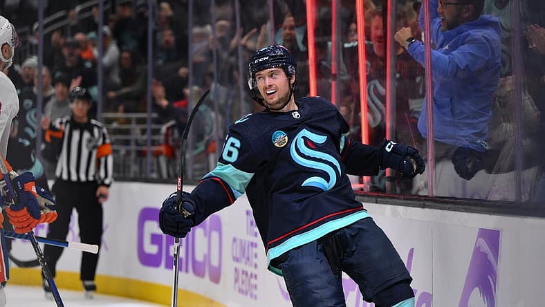 Nov 16, 2023; Seattle, Washington, USA; Seattle Kraken right wing Kailer Yamamoto (56) celebrates after scoring a goal against the New York Islanders during the third period at Climate Pledge Arena. Mandatory Credit: Steven Bisig-USA TODAY Sports