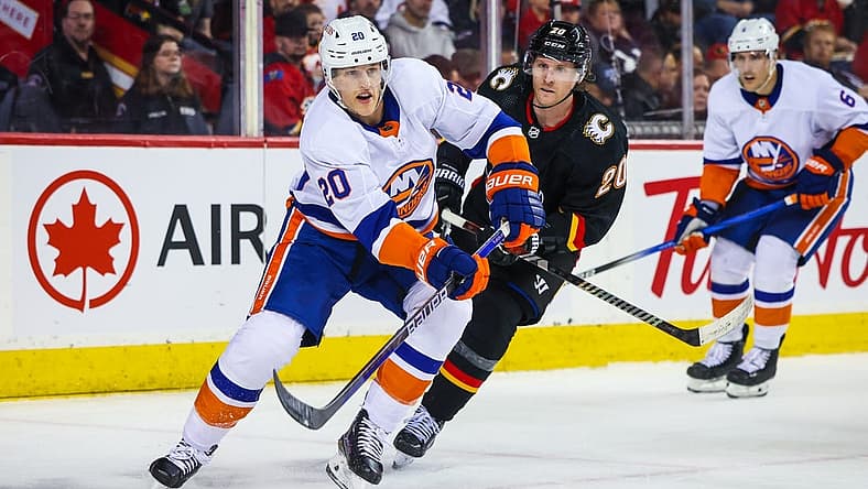 Nov 18, 2023; Calgary, Alberta, CAN; New York Islanders right wing Hudson Fasching (20) passes the puck against the Calgary Flames during the second period at Scotiabank Saddledome. Mandatory Credit: Sergei Belski-USA TODAY Sports