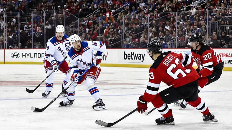 Nov 18, 2023; Newark, New Jersey, USA; New York Rangers left wing Artemi Panarin (10) skates with the puck against New Jersey Devils left wing Jesper Bratt (63) and New Jersey Devils center Michael McLeod (20) during the first period at Prudential Center. Mandatory Credit: John Jones-USA TODAY Sports