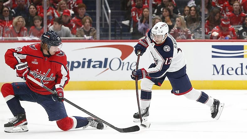Nov 18, 2023; Washington, District of Columbia, USA; Columbus Blue Jackets left wing Johnny Gaudreau (13) shoots the puck as Washington Capitals defenseman Rasmus Sandin (38) defends during the second period at Capital One Arena. Mandatory Credit: Amber Searls-USA TODAY Sports