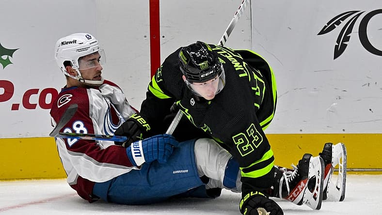 Nov 18, 2023; Dallas, Texas, USA; Dallas Stars defenseman Esa Lindell (23) checks Colorado Avalanche left wing Miles Wood (28) during the second period at the American Airlines Center. Mandatory Credit: Jerome Miron-USA TODAY Sports