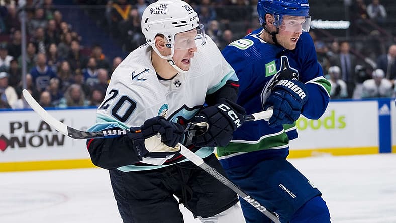 Nov 18, 2023; Vancouver, British Columbia, CAN; Seattle Kraken forward Eeli Tolvanen (20) battles with Vancouver Canucks forward Sam Lafferty (18) in the third period at Rogers Arena. Seattle won 4-3. Mandatory Credit: Bob Frid-USA TODAY Sports
