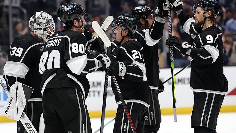 Nov 18, 2023; Los Angeles, California, USA; Los Angeles Kings center Adrian Kempe (9) high-fives with center Anze Kopitar (11) as goaltender Cam Talbot (39) and left wing Pierre-Luc Dubois (80) and defenseman Jordan Spence (21) celebrate a win after defeating the St. Louis Blues 5-1 at Crypto.com Arena. Mandatory Credit: Kiyoshi Mio-USA TODAY Sports