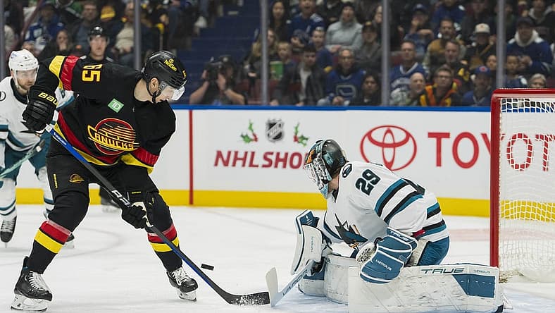 Nov 20, 2023; Vancouver, British Columbia, CAN; San Jose Sharks goalie Mackenzie Blackwood (29) makes a save on Vancouver Canucks forward Ilya Mikheyev (65) at Rogers Arena. Mandatory Credit: Bob Frid-USA TODAY Sports